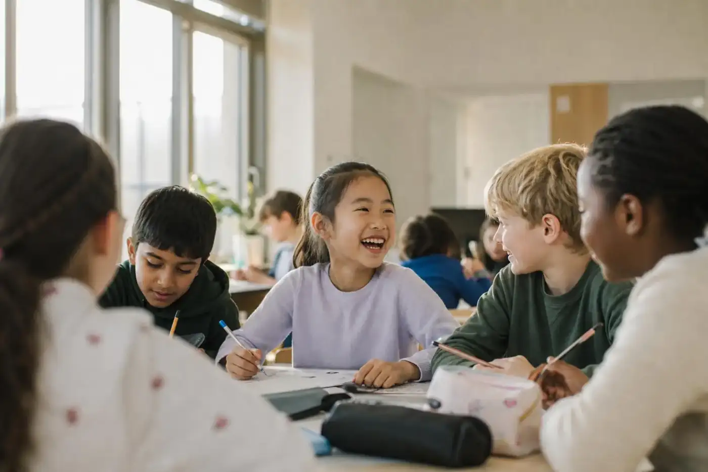 A diverse group of primary-school children working together in a bright international classroom